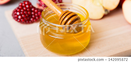 Rosh hashanah, jewish holiday, concept: honey, apple and pomegranate with cutting board, close up Rosh hashanah, jewish holiday, concept: honey, apple and pomegranate with cutting board, close up 142095872