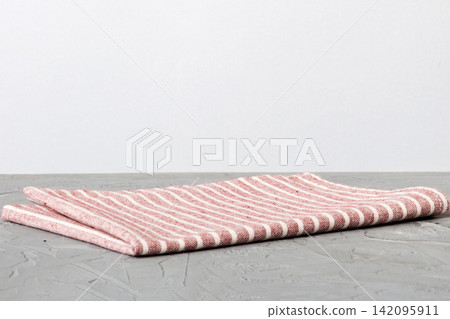 top view with red empty kitchen napkin isolated on table background. Folded cloth for mockup with copy space, Flat lay. Minimal style 142095911