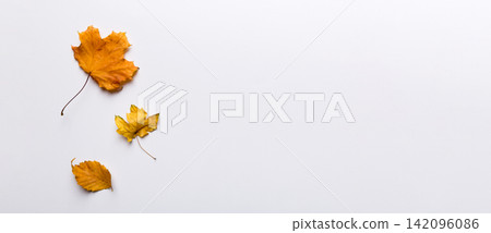 Autumn composition. Pattern made of dried leaves and other design accessories on table. Flat lay, top view Autumn composition. Pattern made of dried leaves and other design accessories on table. Flat lay, top view 142096086