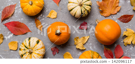 Autumn composition. Pattern made of dried leaves and other design accessories on table. Flat lay, top view Autumn composition. Pattern made of dried leaves and other design accessories on table. Flat lay, top view 142096117