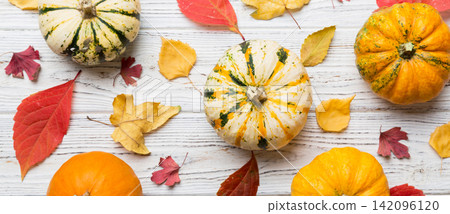 Autumn composition. Pattern made of dried leaves and other design accessories on table. Flat lay, top view Autumn composition. Pattern made of dried leaves and other design accessories on table. Flat lay, top view 142096120