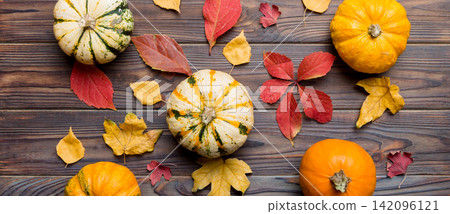 Autumn composition. Pattern made of dried leaves and other design accessories on table. Flat lay, top view Autumn composition. Pattern made of dried leaves and other design accessories on table. Flat lay, top view 142096121