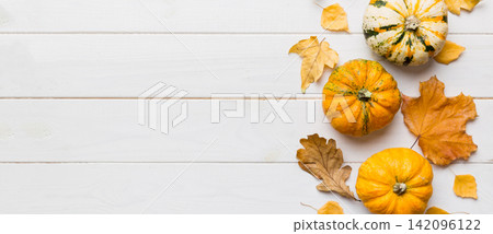 Autumn composition. Pattern made of dried leaves and other design accessories on table. Flat lay, top view Autumn composition. Pattern made of dried leaves and other design accessories on table. Flat lay, top view 142096122