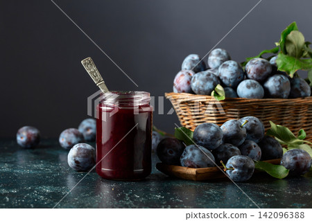 Ripe plums with jam on the kitchen table. Ripe plums with jam on the kitchen table. 142096388