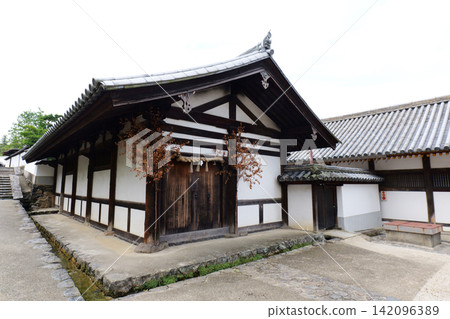 Traditional Japanese old town with stone walls and historic wooden houses in Nara, Japan Traditional Japanese old town with stone walls and historic wooden houses in Nara, Japan 142096389