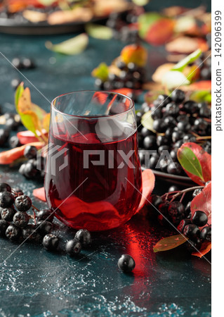 Black chokeberry juice and fresh berries. Black chokeberry juice and fresh berries. 142096399