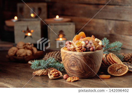 Dried fruits and assorted nuts on an old wooden table. Dried fruits and assorted nuts on an old wooden table. 142096402