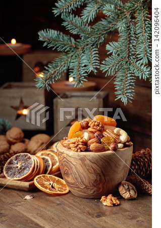 Dried fruits and assorted nuts on an old wooden table. Dried fruits and assorted nuts on an old wooden table. 142096404