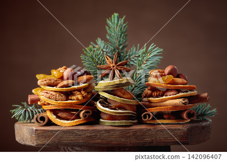 Christmas still-life with dried fruits and nuts. Christmas still-life with dried fruits and nuts. 142096407