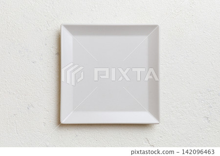 Top view of empty square plate on cement background. Empty space for your design Top view of empty square plate on cement background. Empty space for your design 142096463