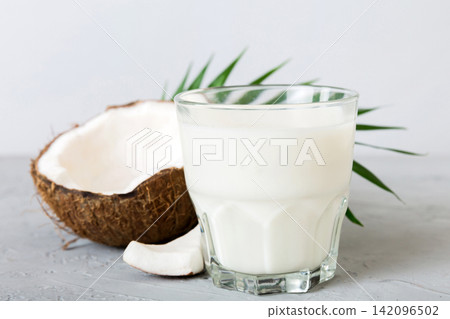 coconut products on white wooden table background. Dairy free milk substitute drink, Flat lay healthy eating coconut products on white wooden table background. Dairy free milk substitute drink, Flat lay healthy eating 142096502