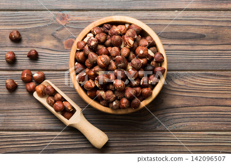 Wooden bowl full of hazelnuts on table background. Healthy eating concept. Super foods Wooden bowl full of hazelnuts on table background. Healthy eating concept. Super foods 142096507