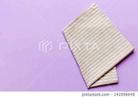 top view with gray kitchen napkin isolated on table background. Folded cloth for mockup with copy space, Flat lay. Minimal style top view with gray kitchen napkin isolated on table background. Folded cloth for mockup with copy space, Flat lay. Minimal style 142096648
