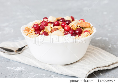 Healthy breakfast food with granola, yogurt, fruits and nuts. Dessert parfait with dried fruits for breakfast Healthy breakfast food with granola, yogurt, fruits and nuts. Dessert parfait with dried fruits for breakfast 142096697