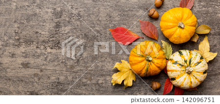 Autumn composition. Pattern made of dried leaves and other design accessories on table. Flat lay, top view Autumn composition. Pattern made of dried leaves and other design accessories on table. Flat lay, top view 142096751