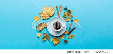 Flat lay composition with colorful Autumn cup of coffee and leaves on a color background. top view Flat lay composition with colorful Autumn cup of coffee and leaves on a color background. top view 142096778