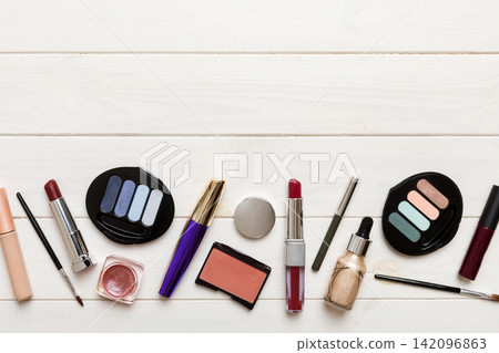 Professional makeup tools. Top view. Flat lay. Beauty, decorative cosmetics. Makeup brushes set and color eyeshadow palette on table background. Minimalistic style Professional makeup tools. Top view. Flat lay. Beauty, decorative cosmetics. Makeup brushes set and color eyeshadow palette on table background. Minimalistic style 142096863