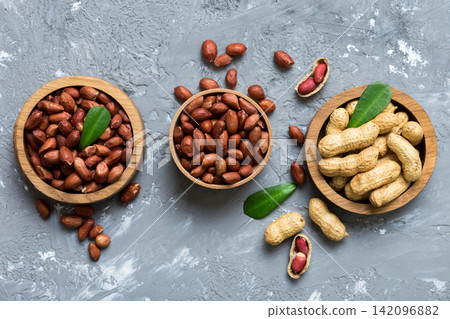 Fresh healthy peanuts in bowl on colored table background. Top view Healthy eating bertholletia concept. Super foods Fresh healthy peanuts in bowl on colored table background. Top view Healthy eating bertholletia concept. Super foods 142096882