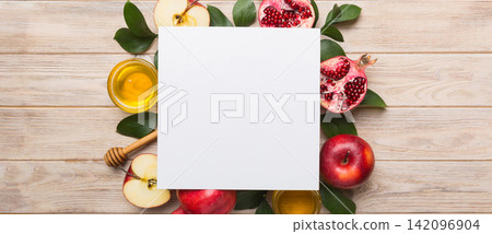 Flat lay composition with Blank flyer poster and symbols jewish Rosh Hashanah holiday attributes on colored background, New Year holiday Traditional. Top view with copy space mock up Flat lay composition with Blank flyer poster and symbols jewish Rosh Hashanah holiday attributes on colored background, New Year holiday Traditional. Top view with copy space mock up 142096904