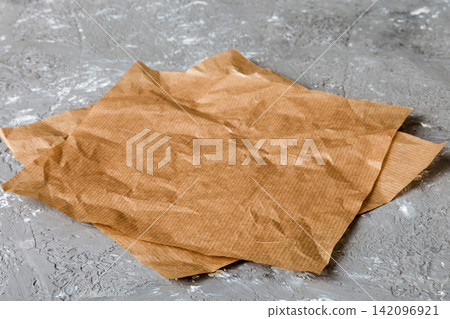 top view with baking parchment empty on table background. Folded cloth for mockup with copy space, Flat lay. Minimal style top view with baking parchment empty on table background. Folded cloth for mockup with copy space, Flat lay. Minimal style 142096921