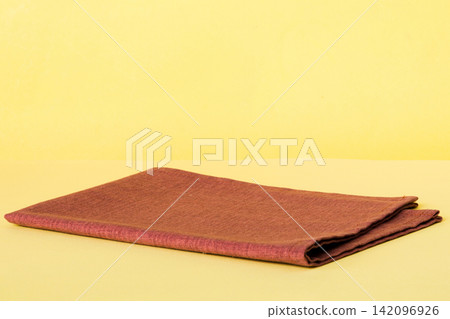 top view with red empty kitchen napkin isolated on table background. Folded cloth for mockup with copy space, Flat lay. Minimal style top view with red empty kitchen napkin isolated on table background. Folded cloth for mockup with copy space, Flat lay. Minimal style 142096926