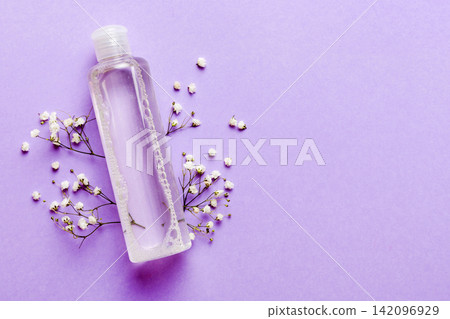 Fancy healthcare bottles for serum, micellar, tonic, toner, lotion, water and cream with gypsophila branch. Natural oranic spa cosmetics concept. Mockup, template, Top view Fancy healthcare bottles for serum, micellar, tonic, toner, lotion, water and cream with gypsophila branch. Natural oranic spa cosmetics concept. Mockup, template, Top view 142096929
