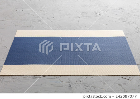 Perspective view of blue tablecloth for food on cement background. Empty space for your design Perspective view of blue tablecloth for food on cement background. Empty space for your design 142097077
