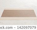 Perspective view of brown tablecloth for food on cement background. Empty space for your design 142097079
