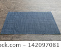 Perspective view of blue tablecloth for food on cement background. Empty space for your design 142097081