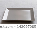 Perspective view of empty square plate on cement background. Empty space for your design 142097085