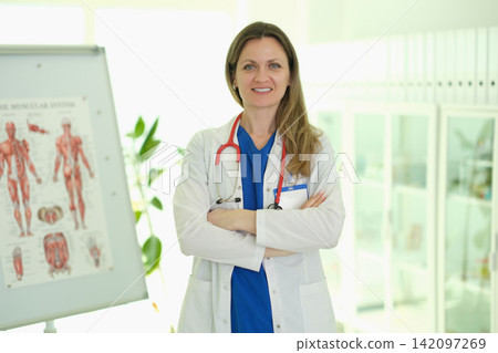 Woman doctor in robe stands in healthcare facility environment Woman doctor in robe stands in healthcare facility environment 142097269