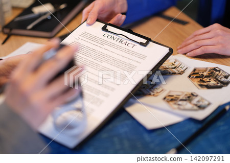 Woman manager applies stamp onto architect designer contract Woman manager applies stamp onto architect designer contract 142097291