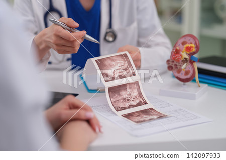 Woman doctor explains kidney ultrasound scan during clinic visit Woman doctor explains kidney ultrasound scan during clinic visit 142097933