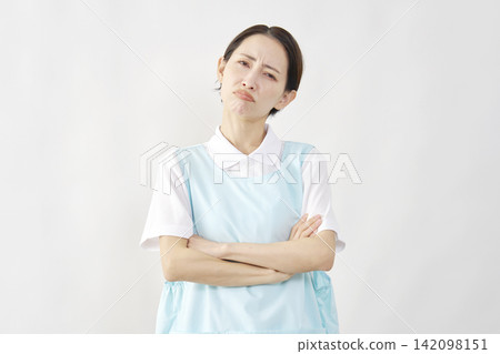 Angry female caregiver, white background, looking directly at the camera. Angry female caregiver, white background, looking directly at the camera. 142098151