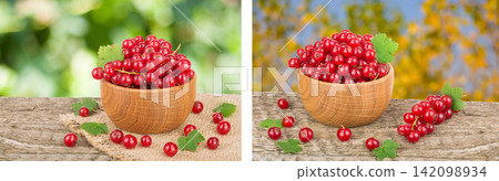Red currant berries in wooden bowl on wooden table with blurry garden background Red currant berries in wooden bowl on wooden table with blurry garden background 142098934
