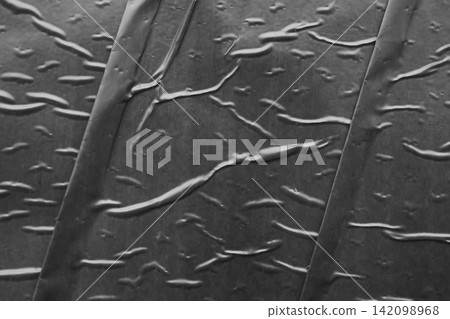 black crumpled and creased plastic poster texture background black crumpled and creased plastic poster texture background 142098968