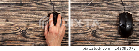 black computer mouse with a hand on a black wooden background with copy space for your text. Top view black computer mouse with a hand on a black wooden background with copy space for your text. Top view 142099073