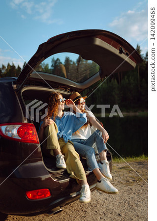 Two Young woman takes a selfie in the car during a road trip. Lifestyle, travel, tourism, nature. Two Young woman takes a selfie in the car during a road trip. Lifestyle, travel, tourism, nature. 142099468