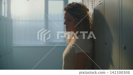 Female Educator Finds Calm Pause in Empty School Changing Area, Creating Space Mentally Reset Female Educator Finds Calm Pause in Empty School Changing Area, Creating Space Mentally Reset 142100308