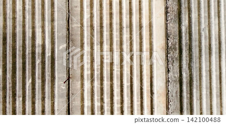 Grooved vertical concrete texture with weathered-looking crevices. Grooved vertical concrete texture with weathered-looking crevices. 142100488