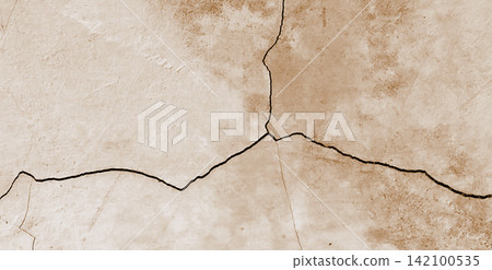 Cracked beige concrete surface with a sepia texture Cracked beige concrete surface with a sepia texture 142100535