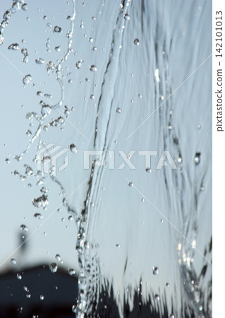 Splashing water with blue background Splashing water with blue background 142101013