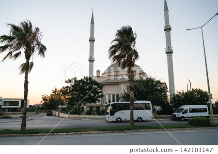 Antalya, Turkey, July 26, 2026: Mosque with twin minarets and domed architecture at sunset Antalya, Turkey, July 26, 2026: Mosque with twin minarets and domed architecture at sunset 142101147