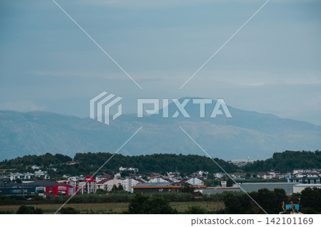Side, Turkey, July 20, 2026: View of the Taurus Mountains overlooking the urban landscape and countryside Side, Turkey, July 20, 2026: View of the Taurus Mountains overlooking the urban landscape and countryside 142101169
