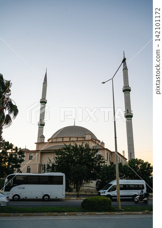 Antalya, Turkey, July 26, 2026: Mosque with twin minarets and domed architecture at sunset Antalya, Turkey, July 26, 2026: Mosque with twin minarets and domed architecture at sunset 142101172