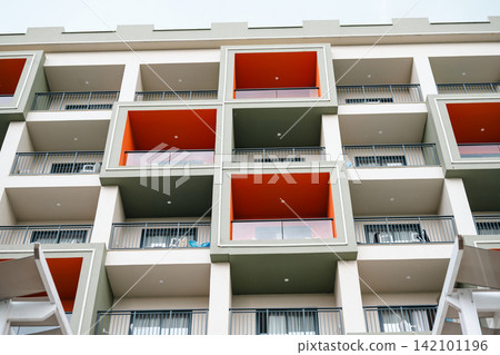 Modern hotel building with colorful balconies, travel holiday leisure background Modern hotel building with colorful balconies, travel holiday leisure background 142101196