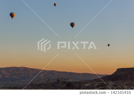 Open Air Museum. Flying hot air balloons rise in sunrise Cappadocia. Goreme National Park Turkey. Open Air Museum. Flying hot air balloons rise in sunrise Cappadocia. Goreme National Park Turkey. 142101410