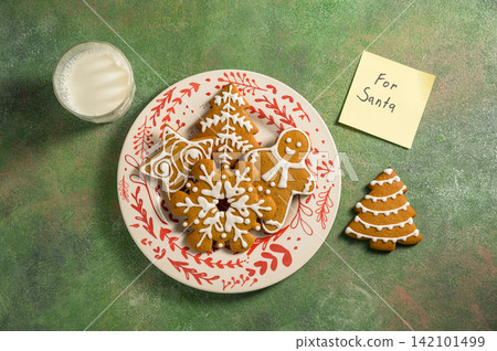 Holiday background. Christmas gingerbread cookies for Santa, festive food, home baking. Flat lay 142101499