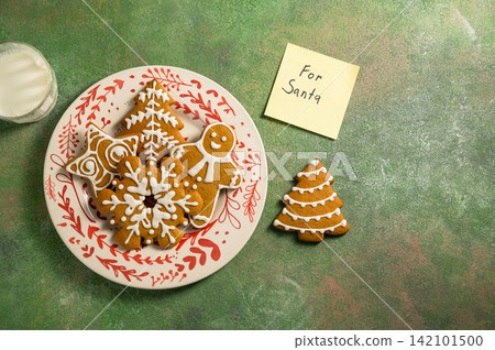 Holiday background. Christmas gingerbread cookies for Santa, festive food, home baking. Flat lay Holiday background. Christmas gingerbread cookies for Santa, festive food, home baking. Flat lay 142101500