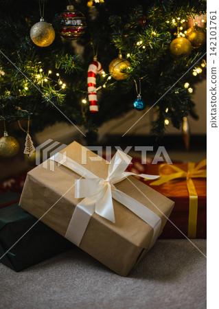 Holiday background, gift boxes next to Christmas tree. Abstract Christmas background, lifestyle Holiday background, gift boxes next to Christmas tree. Abstract Christmas background, lifestyle 142101761